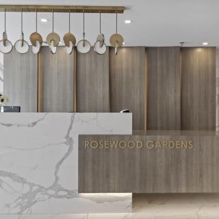 A modern and luxurious reception area with a marble counter and elegant lighting.