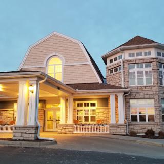 A beautifully designed residential building illuminated in the evening light.