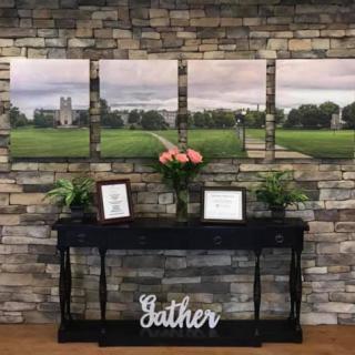 A beautifully arranged interior showcasing landscape photography, complemented by fresh flowers and decorative elements.