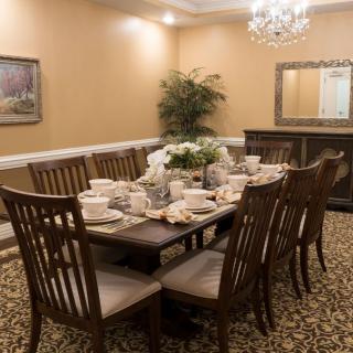 Elegant dining room setup with a large table and formal decor.