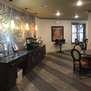 A cozy cafe interior with seating, a coffee station, and decorative elements.