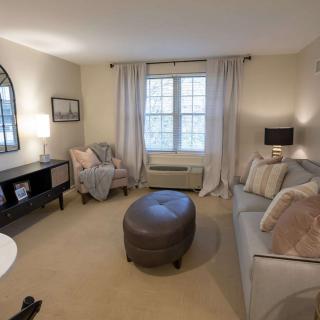 A cozy living room with soft lighting and comfortable furnishings.