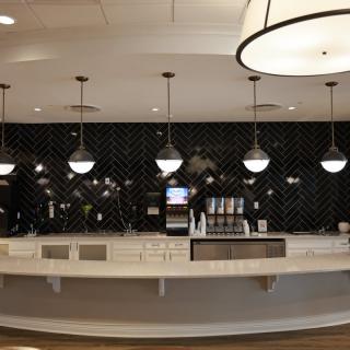 A modern cafe counter with stylish lighting and contemporary decor.