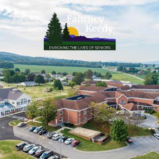 A scenic aerial view of a community building surrounded by lush landscape, showcasing the harmony between nature and education.