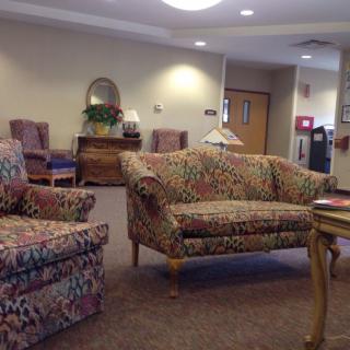 A cozy waiting room with patterned furniture and soft lighting.