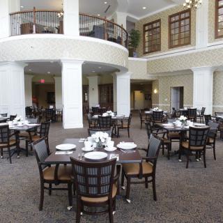 An elegantly designed dining area with neatly arranged tables and chairs.