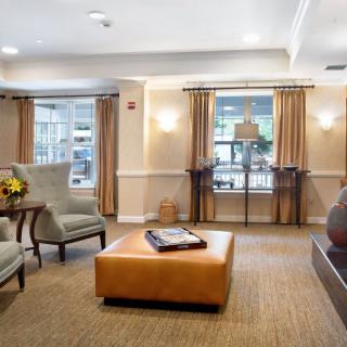 A cozy living room with comfortable seating and ample natural light.