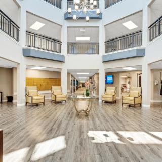 A spacious and modern atrium lobby with ample seating and natural lighting.