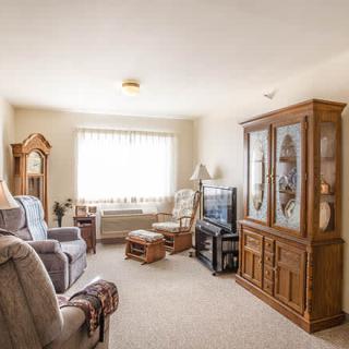 A cozy living room with comfortable armchairs and classic wooden furniture.