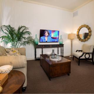 Cozy living room with modern decor, featuring a TV, sofa, and decorative elements.