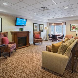 A cozy living room with comfortable seating and a fireplace.