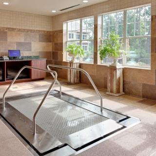 A serene indoor spa area featuring a relaxation pool surrounded by natural light.