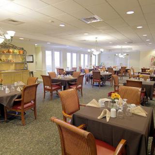 An elegant dining room with neatly arranged tables and chairs.
