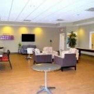 A modern lounge with comfortable seating and a television.