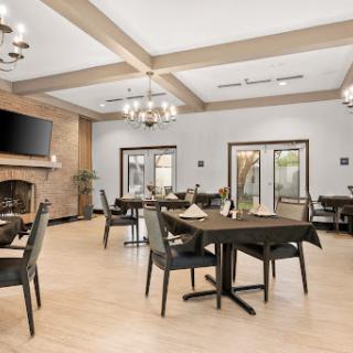 A stylish and modern dining area with elegant wooden furniture and contemporary chandeliers.
