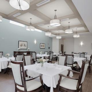 An elegant dining area with neatly arranged tables and modern lighting.
