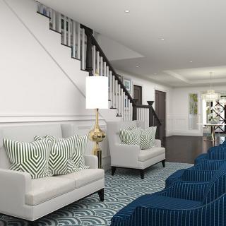 A modern living room with a staircase, featuring white sofas with striped pillows and blue accents.