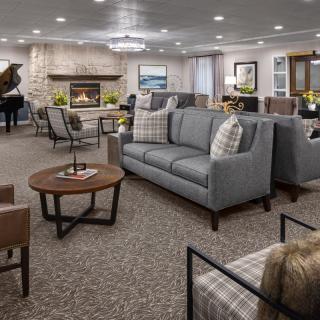 A spacious and elegantly designed living room with modern furniture and a cozy fireplace.