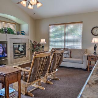 Cozy living room with comfortable seating, a television, and soft lighting.