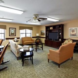 A cozy living room with comfortable seating arranged around a television.