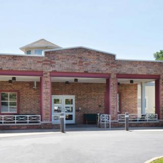 A brick building with an entrance, likely a school.