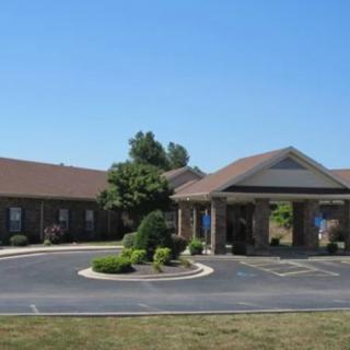 A suburban building with a driveway and landscaped surroundings.