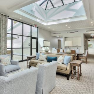 A modern living room with a skylight, featuring stylish furniture and bright, spacious interior design.