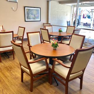 A cozy dining area featuring wooden tables and comfortable chairs.
