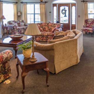 A cozy living room featuring a sofa, coffee table, and decorative items.