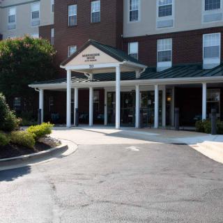 Front entrance of a hotel building with a covered walkway.
