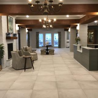 Modern lobby with seating area and chandelier lighting.