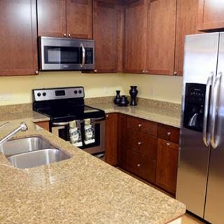 A modern kitchen featuring stainless steel appliances and elegant granite countertops.