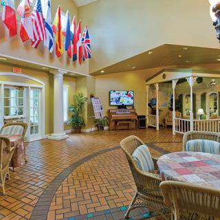 A welcoming lobby with various international flags and comfortable seating.