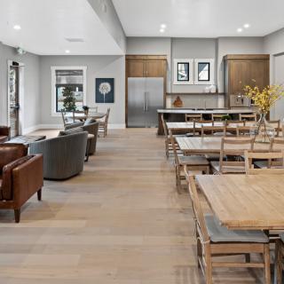 A modern open-concept living area featuring a kitchen, dining table, and seating area with contemporary decor.