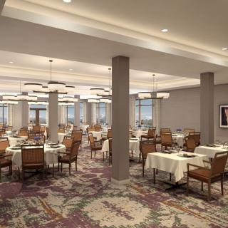 An elegant restaurant dining room with neatly arranged tables and chairs, accented by decorative chandeliers.