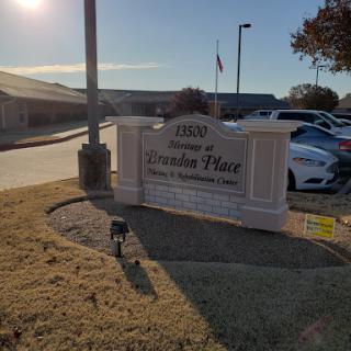 Entrance sign for a facility, capturing the sunny outdoor environment.