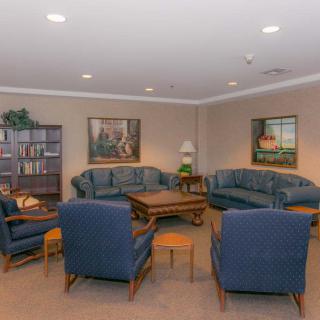 A cozy living room with sofas, chairs, and a coffee table.