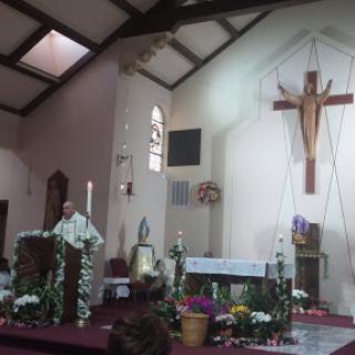 A priest delivering a sermon in a church during a religious service.