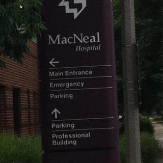 Directional sign for MacNeal Hospital indicating various facilities.