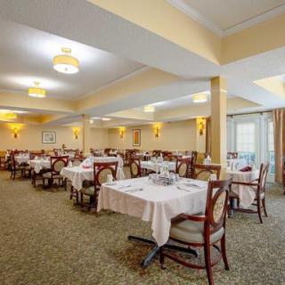 A spacious restaurant dining area with neatly arranged tables and chairs.