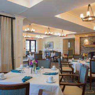 A well-arranged dining room with neatly set tables and comfortable seating.