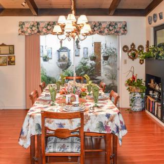 A cozy dining room with a beautifully set table and warm decor.