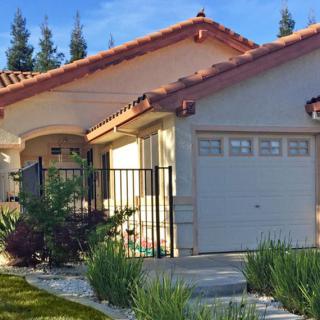 A suburban house with a garage and a small garden in front.
