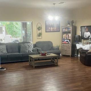A cozy living room with a sofa, coffee table, and television.