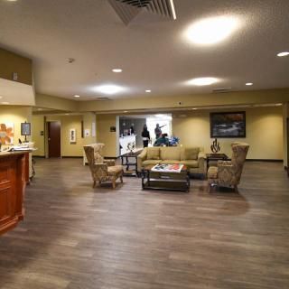 A modern lobby with a reception area and comfortable seating.