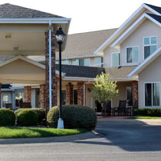 A well-maintained residential building with lush landscaping and ample parking.