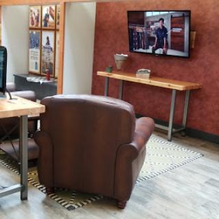 A cozy living space featuring a leather armchair and TV.