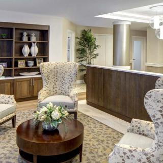 A cozy lobby area with elegant furniture and decorative elements.
