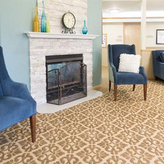 Cozy living room with a fireplace and blue armchairs.