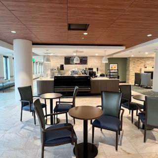 A spacious and modern cafe area featuring seating arrangements for guests.